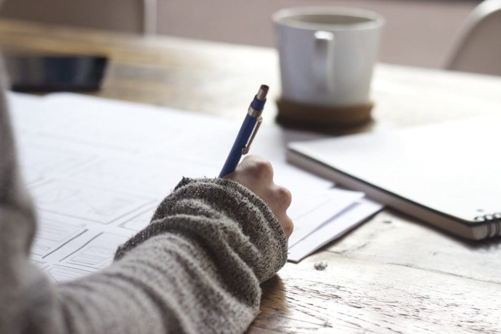 woman writing with pen