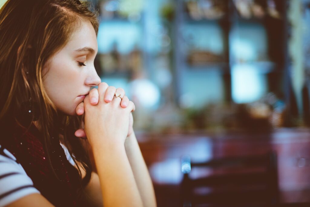 woman praying over decision to quit drinking alcohol 